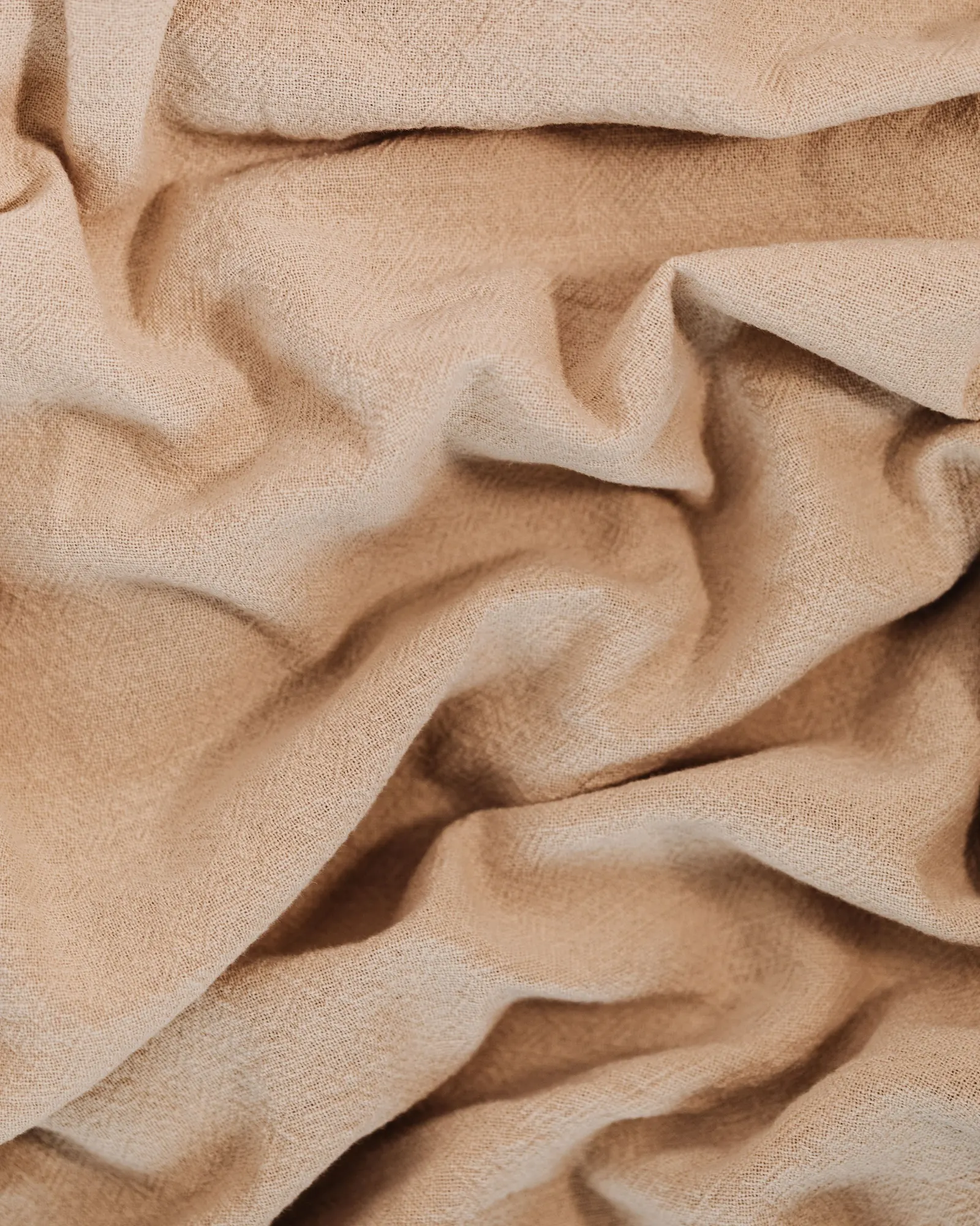 Soft folds of beige cotton cloth